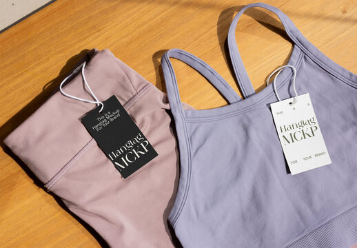 Stylish activewear is displayed on a wooden surface, featuring a hang tag mockup