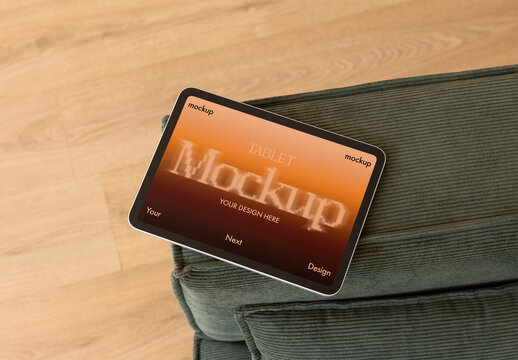 Mockup of tablet placed on a cozy green couch