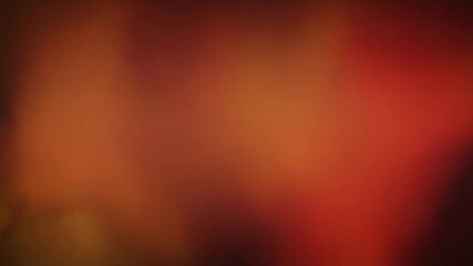 Warm orange and red abstract gradient background with soft light bokeh effects and subtle dark vignette - Powered by Adobe