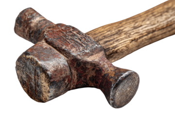 Close-up of a rusty, antique hammer head and handle.  The aged metal head, with visible oxidation, is crossed, and the wooden handle is worn