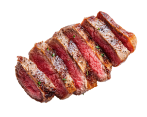 Sliced steak, medium-rare, seasoned, and ready to eat.  A top view of several slices of steak, showcasing a slightly pink interior with browned edges.  Seasoning is visible on the surface