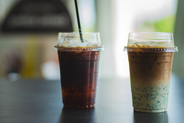 Two glasses of iced coffee on table in coffee shop.