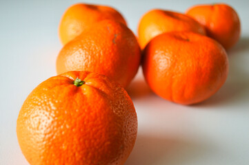 Fresh ripe mandarins with textured peel on white background - healthy citrus fruit