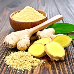 Ginger root and powder on a wooden table
