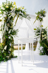 Wedding decor with fresh anthurium flowers, hydrangeas and greenery outdoors near the water. Wedding 