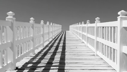 White wooden pier with a black and white photo of it. The photo is of a pier with a white fence