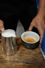 Master barista crafting a creamy latte with rich espresso and frothy milk on rustic wood, perfect for coffee lovers and cozy cafe vibes everywhere