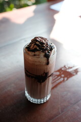 Indulge in a rich chocolate shake, creamy and decadent, perfect for a refreshing treat on a bright sunny day or a sweet escape any time