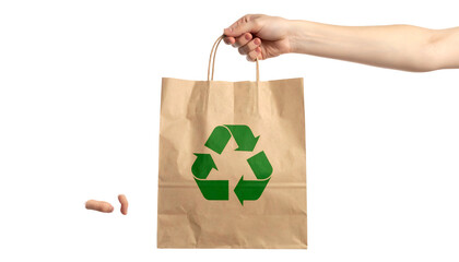 A hand holding a paper bag with a green recycle symbol. Black background with hand/fingers