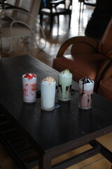 Indulge in a vibrant assortment of delicious milkshakes, perfect for cafes, menus, or promoting refreshing summer treats in a trendy, inviting setting