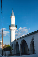 White minaret reaching for the blue sky in Pano Lefkara, Cyprus