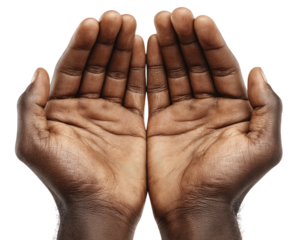 Two dark brown hands, palms up, in a prayerful or supplicating pose