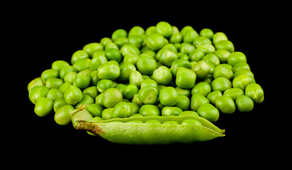 Green peas isolated on black background.