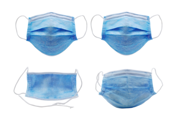 Four light-blue disposable face masks, various orientations