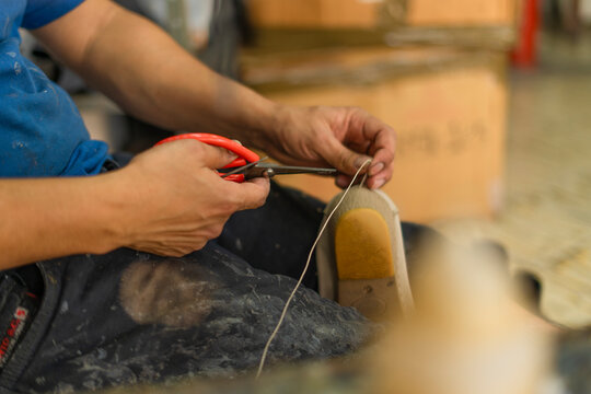 Detail of a shoemaker's hands repairing shoes