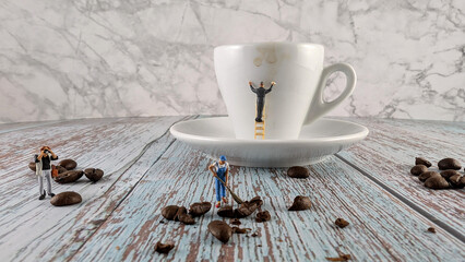 Miniature figures cleaning: one wiping an espresso cup, another sweeping coffee beans, while a photographer captures the scene. 