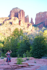 Blonde woman wearing alien sunglasses poses at Crescent Moon Ranch with Cathedral Rock in Sedona Arizona