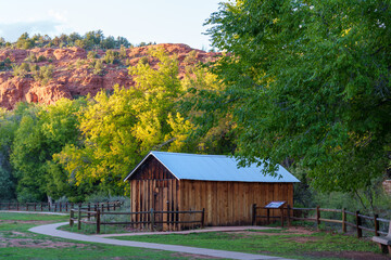 Historic ranch at Crescent Moon Ranch in Sedona, with Cathedral Rock in the background at sunset