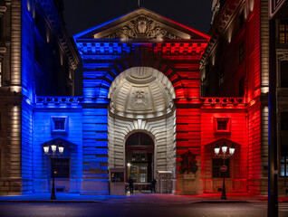 Paris, France - 10 15 2025: View entrance of the Police Prefecture building facade on the Ile de la Cité illuminated with French flag colors