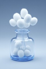 Fluffy white balls in a clear glass vase against a blue background.