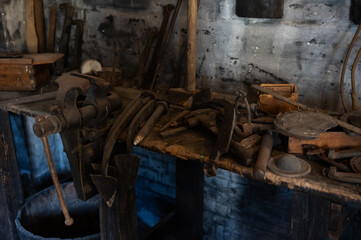 Wooden table with old metal craft tools, rustic.