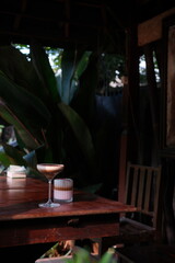 Indulge in decadent cocktail hour with layered drinks on rustic wooden table, perfect for a modern cafe menu or vibrant lifestyle blog post