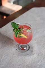 Refreshing strawberry cocktail with mint and lemon, perfect for summer relaxation and vibrant gatherings with friends around the table, cheers to life