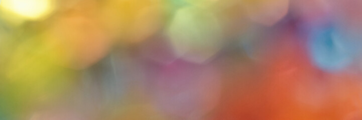 Colorful abstract bokeh background with vivid rainbow shades and soft focus effect.
