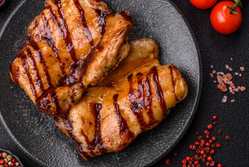 Grilled boneless chicken legs baked on the barbecue for lunch. Grilled chicken as a background