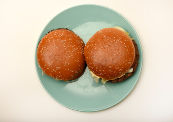 Hamburger with meat and vegetables. Fast food. Hamburger on a plate.