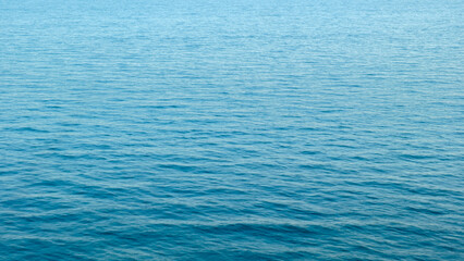 Wide panorama of blue clear sea water surface as background for web banner template page design or wallpaper