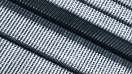 Close-up of long mounting brackets assembled for loading into an industrial packaging machine