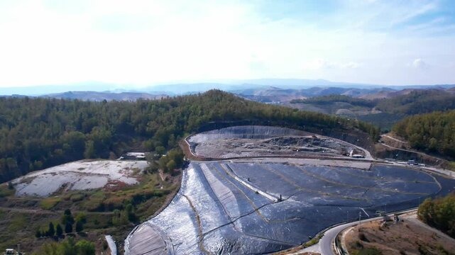 Waste processing technologies. A drone inspects a landfill gas collection system. A large black casing covers the waste&mdash;a crucial component of the landfill gas collection system.