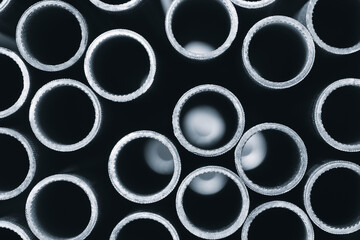 Metal pipes lay on top of each other as an industrial backdrop for a web banner page template design.
