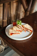 Delicious quesadillas with fresh tomato salsa, perfect for a light lunch or snack, beautifully plated on a wooden table for an authentic vibe