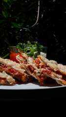 Tempting puff pastry pizza slices with tomato sauce and fresh parsley, perfect for a casual meal or appetizer, presented outdoors in natural light