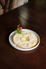 Indulge in this cheesy baked tortilla with a vibrant red sauce, a perfect appetizer for sharing at...