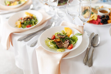 a beautifully decorated banquet table in a restaurant with salads