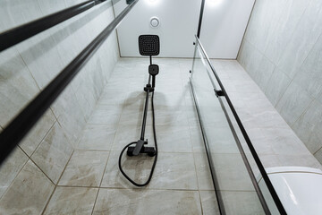 modern shower design, contemporary bathroom featuring tall tiled walls and rain shower, elegant...