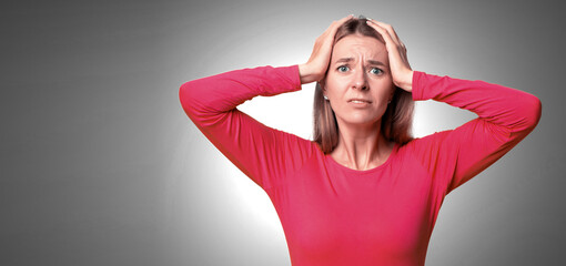 A woman in a red long-sleeve shirt looks distressed, pressing her hands to her head. She shows...