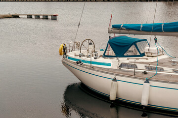 Obraz premium Sailboat Moored in a Marina on a Cloudy Day