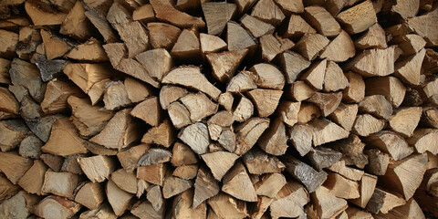 A Stack of Seasoned Firewood Ready for Winter Split Logs Piled High for Cozy Evenings by the Hearth Natural Fuel Source for Wood Stoves and Fireplaces