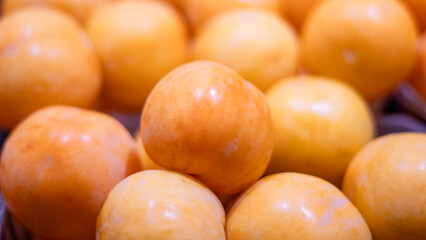 A close-up image of fresh yellow peaches with smooth skin and vibrant color. Perfect for illustrating summer fruits, natural produce, healthy eating, and organic food markets.