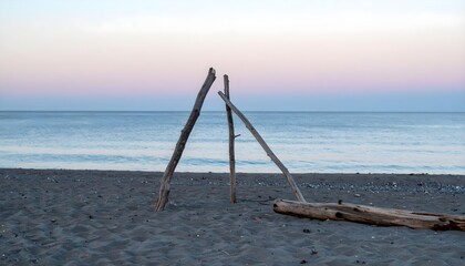 Minimal Driftwood Structure on Peaceful Beach at Sunset