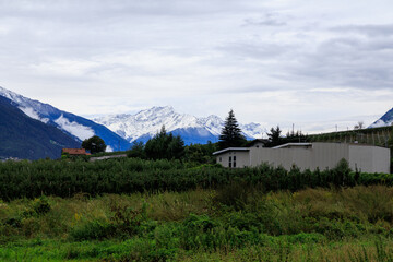 Mountain panorama with snowcapped mountains and summit Laaser Spitze (Orgelspitze) in Ortler Alps and valley Etschtal on a cloudy day in autumn in South Tyrol, Italy