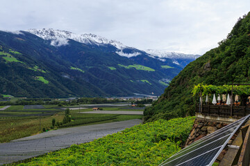 Mountain panorama with snowcapped mountains of Zufrittkamm in Ortler Alps and valley Etschtal on a cloudy day in autumn in South Tyrol, Italy