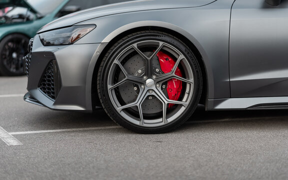 Close up side view of satin grey Audi RS6: front wheel, fender, bumper and headlight. November 14 2024 - Detroit, MI, USA.