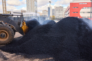 Heavy Machinery Loading Black Aggregate Material at the Construction Site for Development
