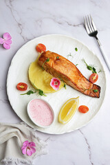 Delicious Grilled Salmon served alongside Creamy Mashed Potatoes and Fresh