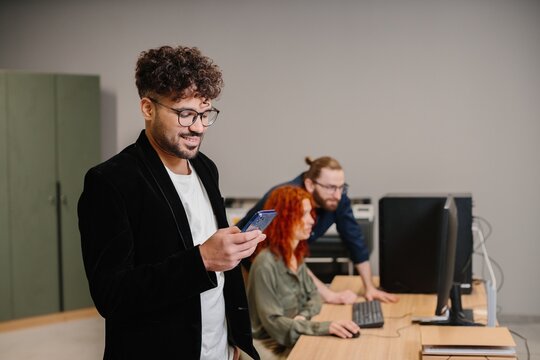 Young businessman using smartphone in modern office